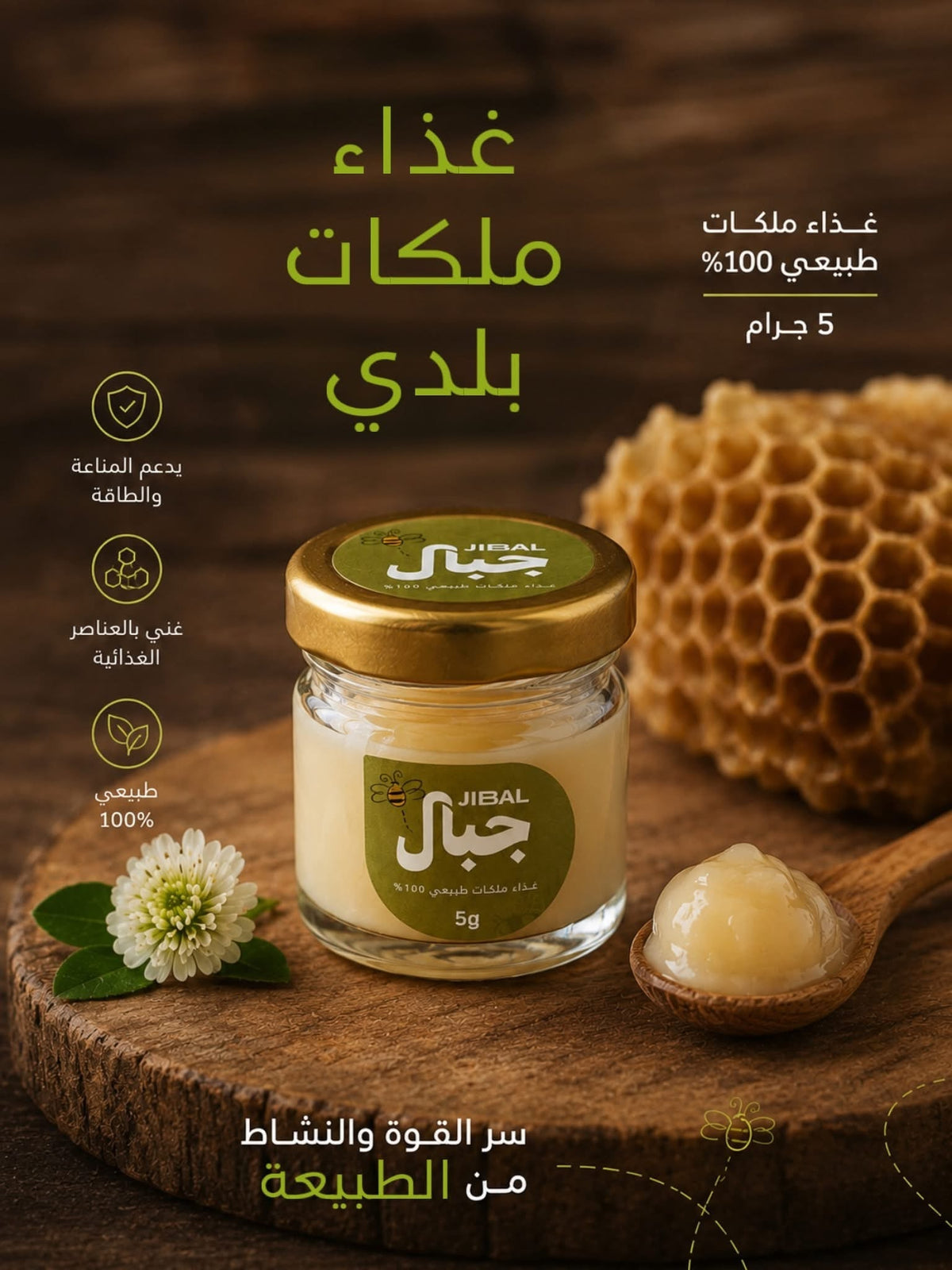 عبوة زجاجية صغيرة 5 جرام من غذاء الملكات البلدي من جِبال بغطاء ذهبي، بجوار ملعقة خشبية وقرص شمع عسل